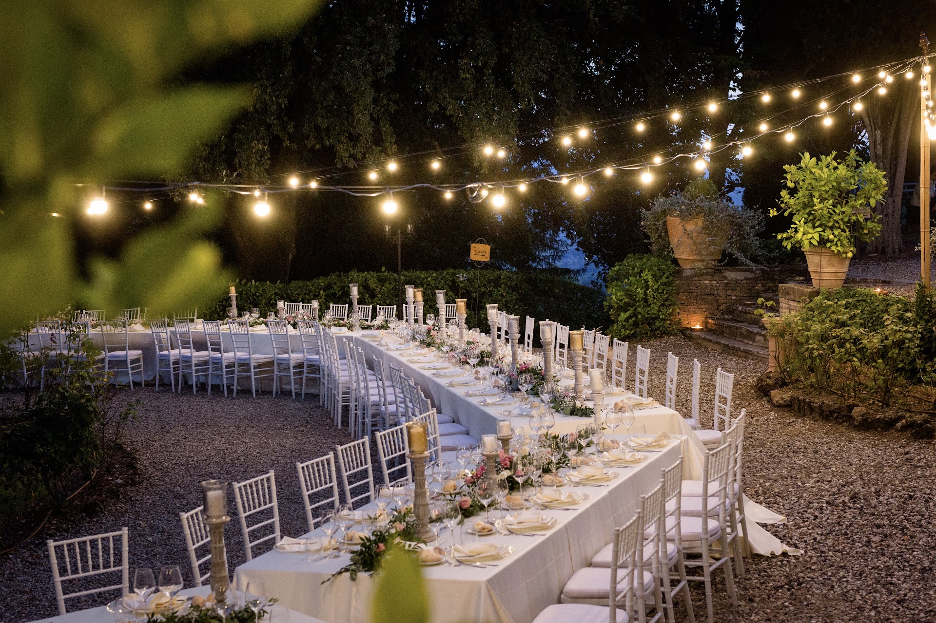 Evening reception under string lights in the villa garden