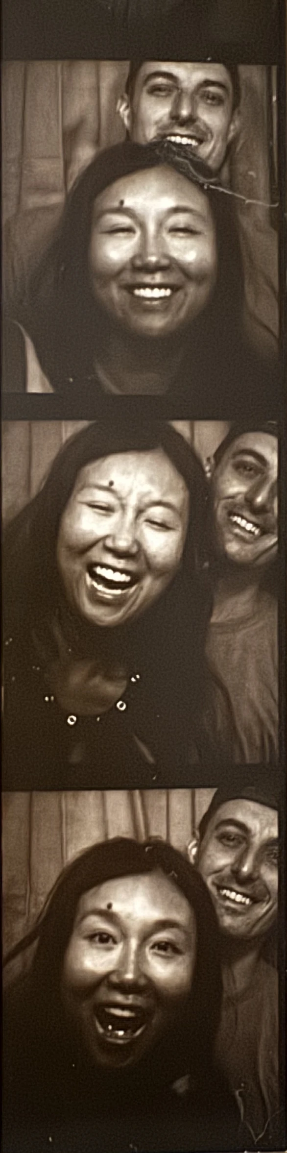 A photo-booth strip of Nancy and Alexander laughing together